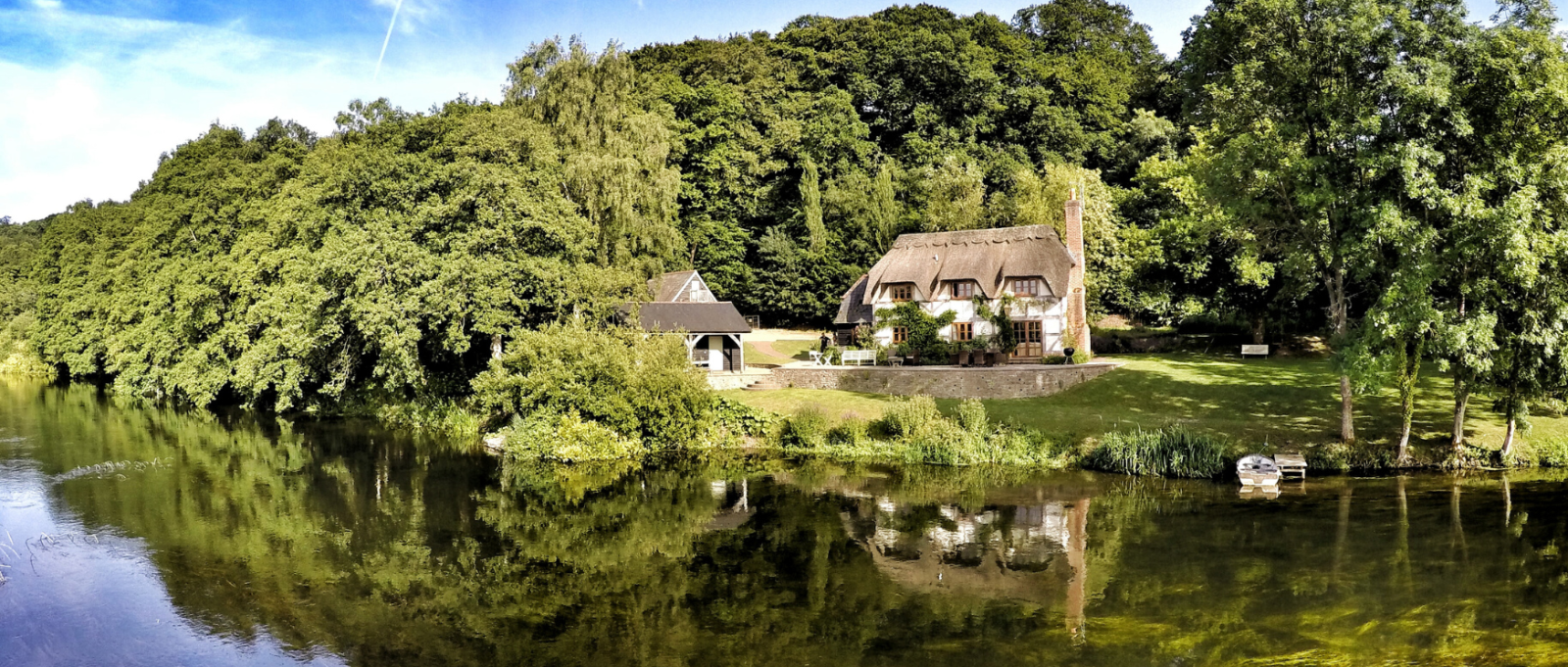 The historic exterior of Undercastle Cottage surrounded by trees